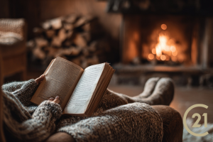 Picture of person reading in front of a fireplace