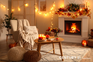 Picture of a living room decorated for fall with a fire in the fireplace